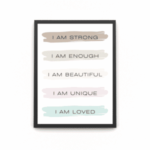 A wooden A4 black frame with the affirmations saying ' I AM ENOUGH I AM LOVED I AM BEAUTIFUL I AM UNIQUE I AM STRONG