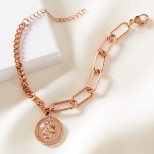 Audrey Hepburn dual stainless steel Rose gold bracelet placed on cream cloth next to a Soul Analyse box