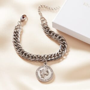Audrey Hepburn chunky silver stainless steel bracelet resting on a cream sheet with a soul analyse box in the corner