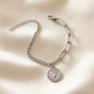Audrey Hepburn dual stainless steel silver bracelet placed on cream cloth