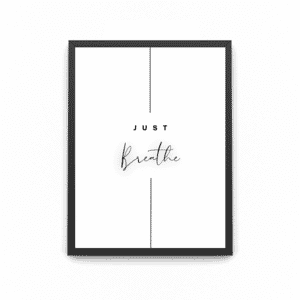 A wooden art framed poster which says 'JUST BREATHE'