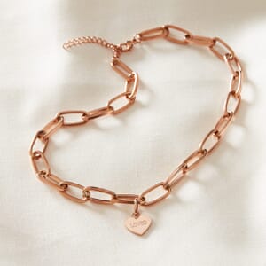 Photo of Rose Gold loved chain necklace placed on a cream cloth