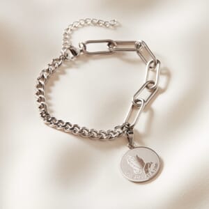 photo of Serenity dual stainless steel silver bracelet placed on cream cloth