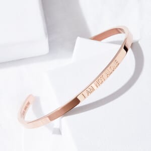 I AM NOT ALONE rose gold stainless steel bracelet placed on a soul analyse box