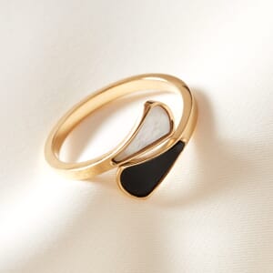 Gold Yin Yang adjustable ring placed on a cream cloth