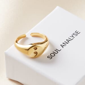 semi colon gold plated sterling silver oval signet ring placed on soul analyse ring box